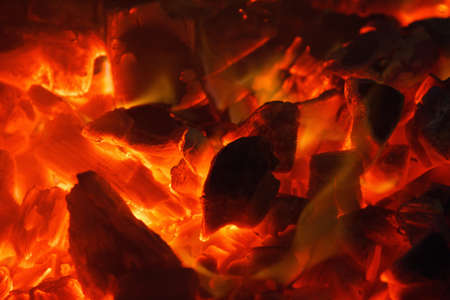 Glowing hot charcoal briquettes close up background texture. bonfire coalsの写真素材