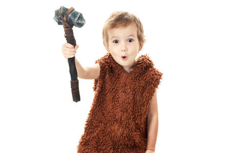 Cute cheerful naughty child playing with axe. Humorous concept ancient caveman isolated on white backgroundの写真素材