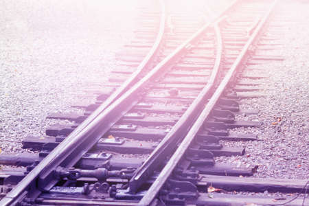 Empty Railroad in fog with diagonal railway backgroundの写真素材