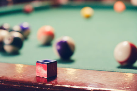 Vintage old balls and chalk on the billiard table.