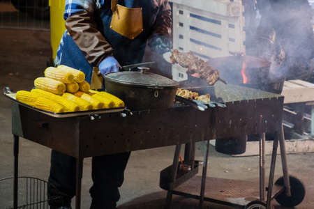 Hot grilled food at the festival of street fast food, sausages, hot dog, fried meat. corn at the festival of street fast foodの写真素材