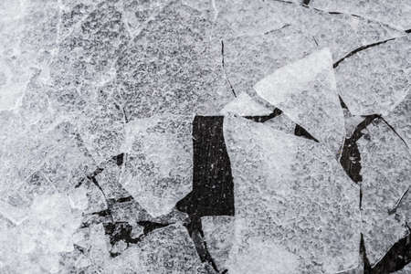 Winter time Broken and refrozen ice surface Ice fragments on water surface in top viewの写真素材
