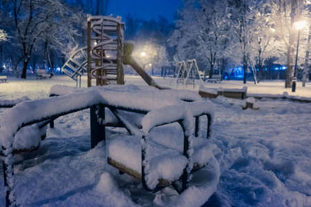 Night park playground caroucel covered with snowの写真素材