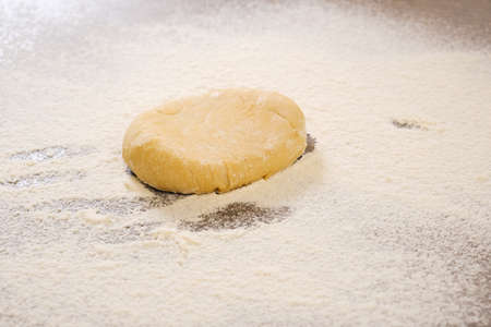 Unleavened dough for tortillas with rolling pin on kitchen table. Cooking burrito. Raw burritosの写真素材