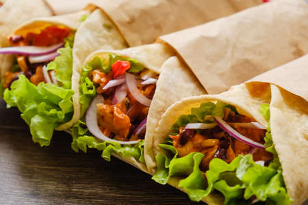 Mexican burrito with chicken, vegetables, pepper and beans. Burrithos takos food close upの写真素材