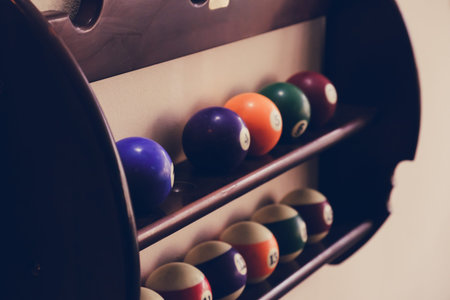 Balls for pool billiards on the shelf, billiard balls for American billiards colored on a wooden...
