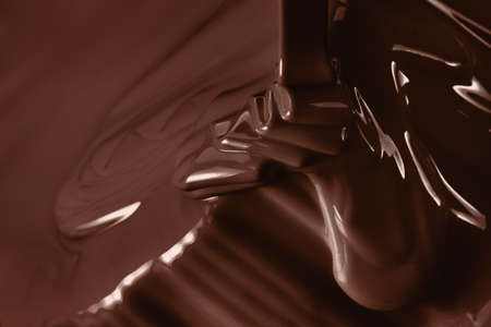 Pouring liquid hot chocolate from above closeup. Cooking dessert.の写真素材