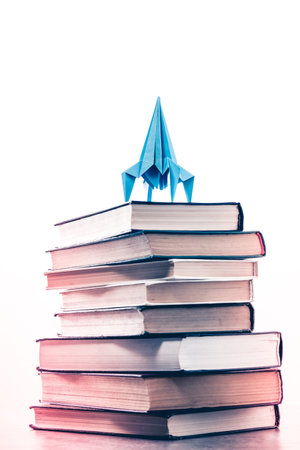 Back to school concept rocket is on books. Idea of knowledge and aspirations in make a career on white backgroundの写真素材