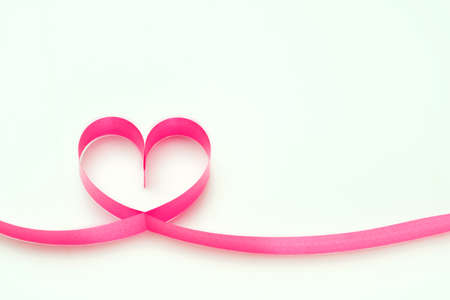 Ribbons shaped as hearts on white, valentines day concept cardの写真素材