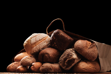 Fresh fragrant bread on the table. Food concept Wheat pastry in a paper bag