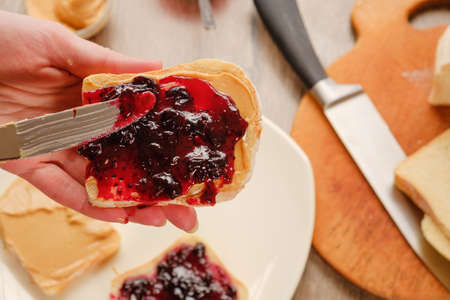 peanut butter sandwich with jam. Cutting board, Kitchen knife.の写真素材