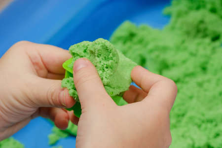 Children playing kinetic colored sand. Kids Gamesの写真素材