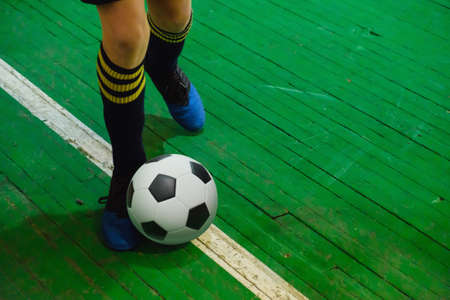 Children teen training soccer futsal indoor gym. Young boy with soccer ball training indoor football. Little player on playgroundの写真素材