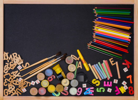 School supplies side border on a chalkboard background