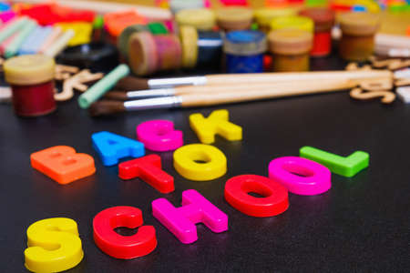 School supplies side border on a chalkboard background with text back to schoolの写真素材