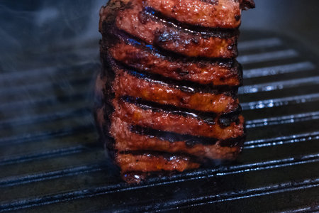 Beef steak fried in a frying pan grill closeupの写真素材