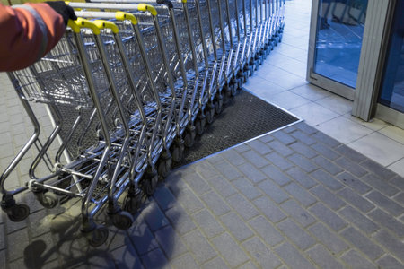 Empty shopping trolleys stands at the supermarket