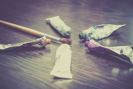 Artist paint brushes on wooden background, handmade craft art processの写真素材