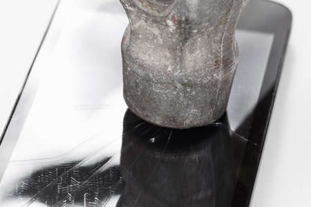 Crack glass display of the smartphone or a tablet, the result of falling, hitting or damaging the hammer.の写真素材