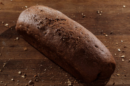 freshly baked bread on wooden kitchen table, top view