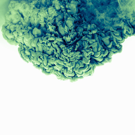 ink in the water. A splash of green yellow paint. Abstract background colorの写真素材