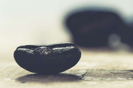 shiny fresh roasted coffee macro beans on wooden background close upの写真素材