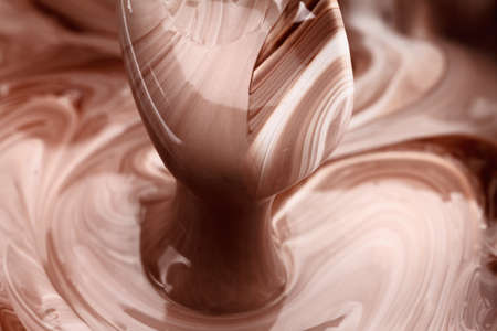 Abstract background, hot, melted chocolate and milk mixing patternの写真素材