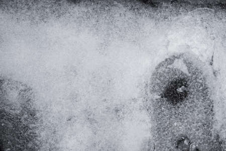 Winter time Broken and refrozen ice surface Ice fragments on water surface in top viewの写真素材