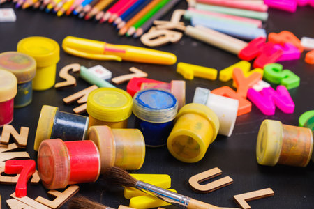 School supplies on blackboard background ready for your design