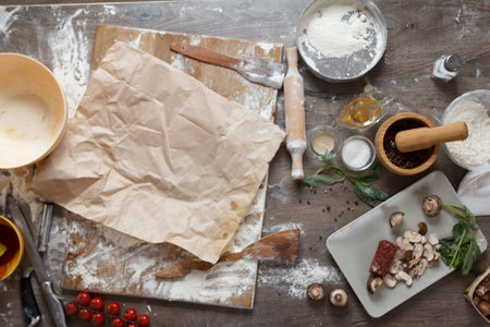 Raw dough for pizza with ingredients and spices on table top view.の写真素材