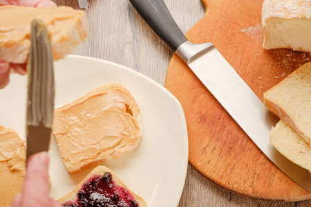 peanut butter sandwich with jam. Cutting board, Kitchen knife.の写真素材