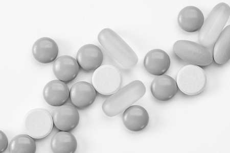 white pills and tablets isolated on white background macroの写真素材