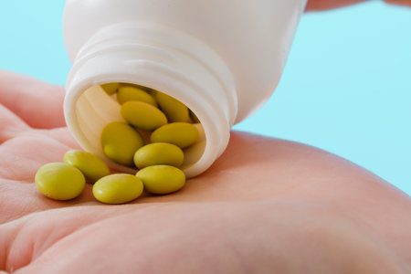 Close up woman pours the pills out of the bottle. Medicine and health care concept.