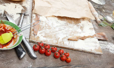 Raw dough for pizza with ingredients and spices on table top view.の写真素材