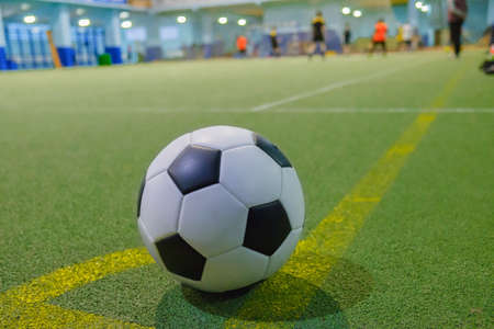 Soccer ball on a corner kick line on an artificial green grass field futsal mini footballの写真素材