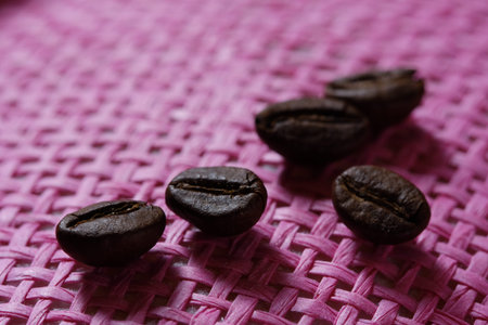 Set of fresh roasted macro coffee beans on pink wicker basket background.の写真素材