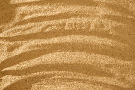 Undulating art flowing wave pattern and concentric circles raked in the sand for wellness and tranquility with copy spaceの写真素材