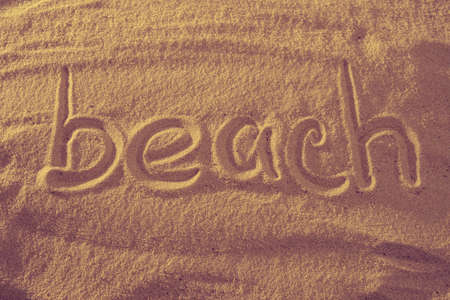Word beach in the sand against the sea sun. concept symbol of holiday.の写真素材