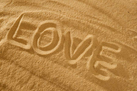 Love written in the sand on a beach, holiday conceptの写真素材