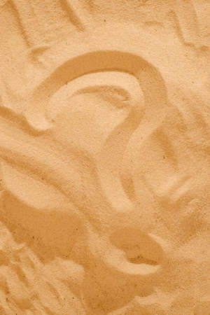 Question What and question mark symbols handwritten in white sand beachの写真素材