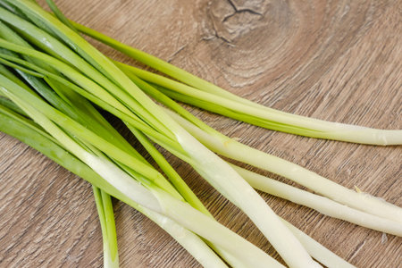 Heap of fresh onion on the wooden background