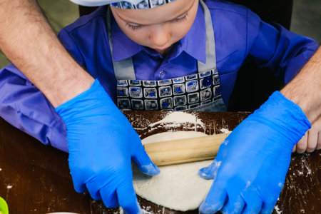 Children make pizza. Master class for children on cooking Italian food. Learn to cook a pizza kid...