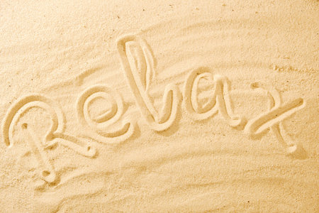 Word Relax on sand beach concept background idea