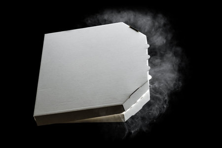 Empty open cardboard pizza box, with hot steam, isolated on black background