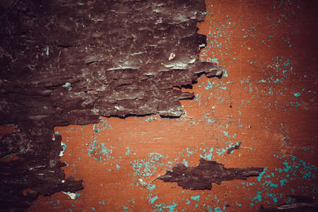 Texture of a peeling orange paint on an old wooden surface.の写真素材