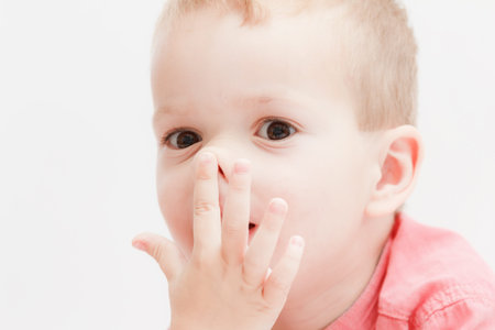 tender lips, nose and finger of a child baby wake up, closeup