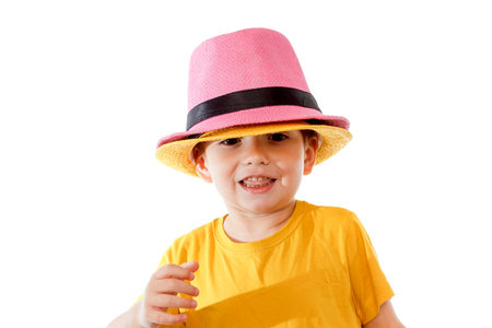 Little caucasian boy in hat is dancing, isolated on white. Little cute cheerful humor kid is dancing...