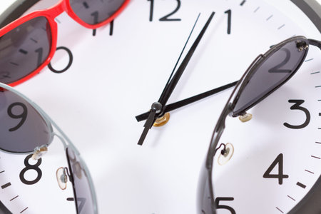 Wall clock isolated on white background. With sunglasses