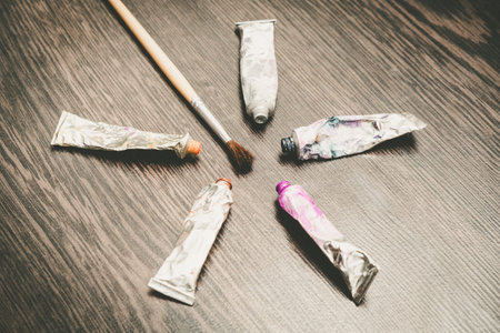Artist paint brushes on wooden background, handmade craft art process