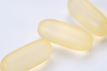 yellow pills capsule isolated on white background macro